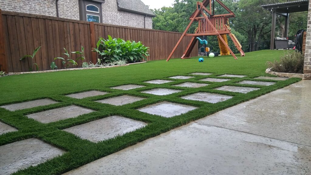 backyard with artificial lawn installation