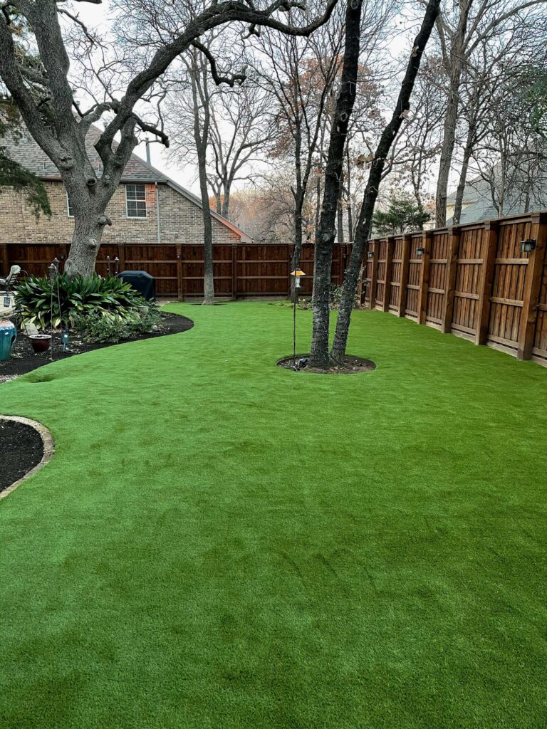 backyard with artificial lawn installation