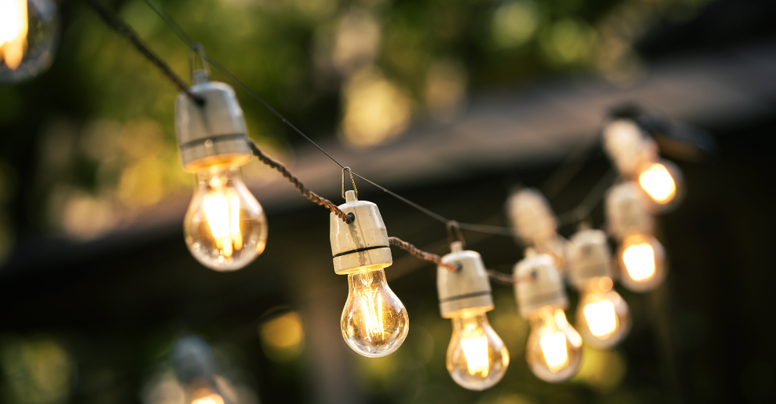 String lights are illuminated as part of a patio's design