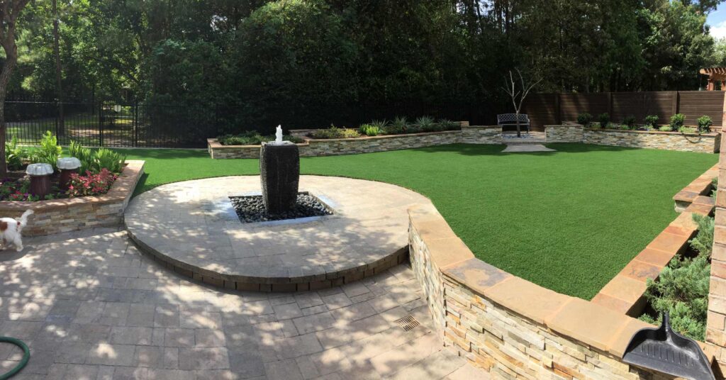 Artificial grass area with a fountain